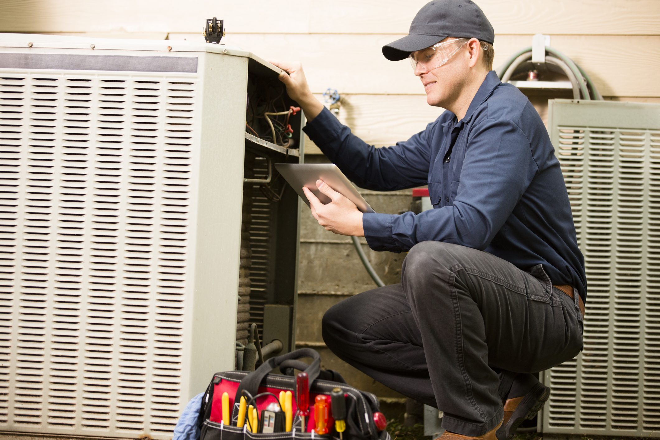 HVAC technician repairing unit